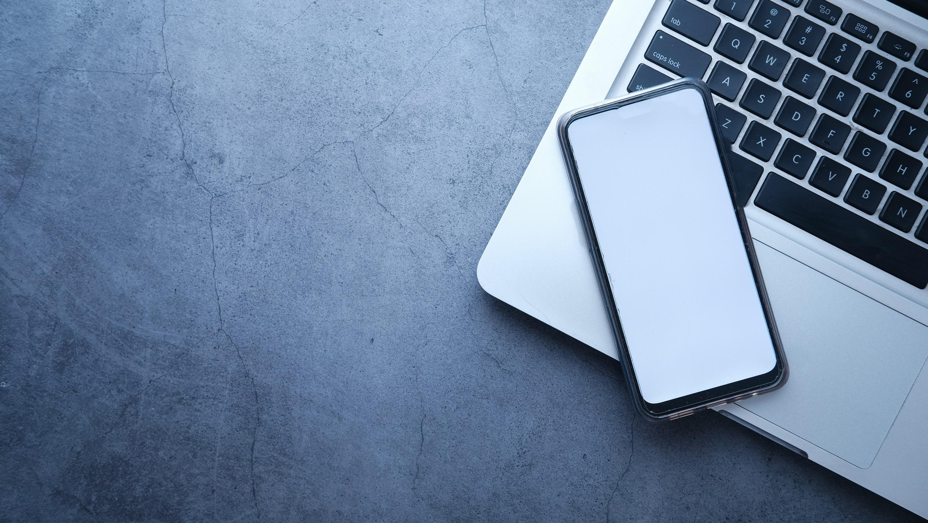 Modern workspace with laptop and mobile device for business technology services